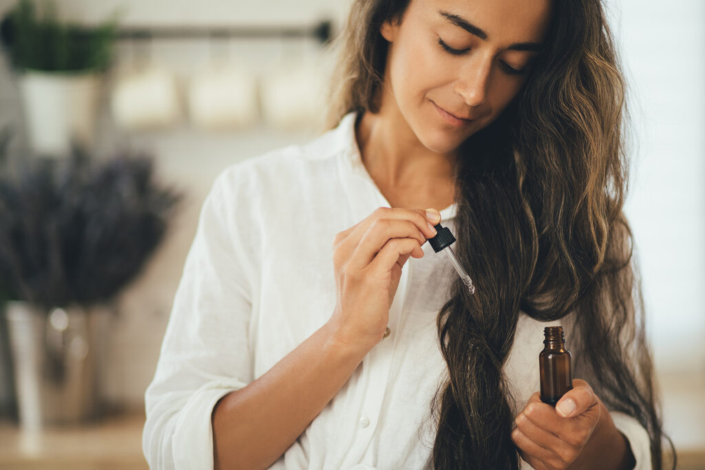 Onde comprar óleo essenciais de qualidade, mulher com óleo essencial em aromaterapia e autocuidado